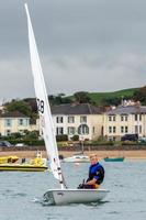 APPLEDORE, DEVON, UK, 2013. Young man sailing in the Torridge and Taw Estuary in  Devon photo