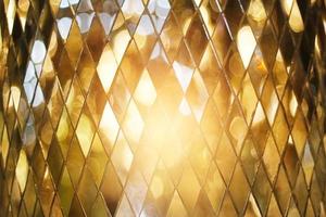 Shining golden mosaic glass background photo