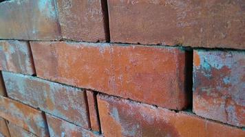 Close up view of red brick wall texture. Abstract background of a brick wall with a diminishing pattern photo