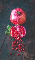 Fresh pomegranate on the wooden table photo