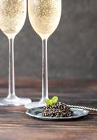 Black caviar with champagne photo