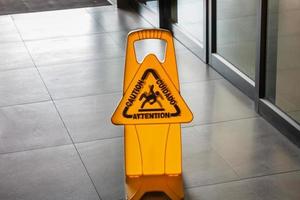 Sign showing warning of caution wet floor photo