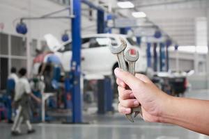 Hand of professional Auto mechanic with wrench photo