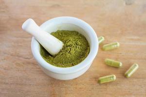 Fresh herbs powder in the mortar, alternative medicine photo