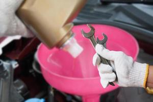 Mechanic holding pair of wrenches at the repair garage photo