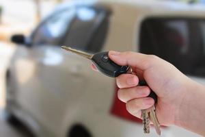 women's hand presses on the remote control car alarm systems photo