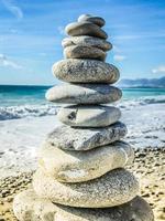 High pebble stack, sea in background photo