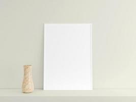 Customizable minimalist vertical white poster or photo frame mockup on the podium table with vase. 3D Rendering.