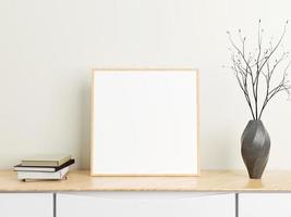 cartel minimalista de madera cuadrada o maqueta de marco de fotos en una mesa de madera con libros y jarrón en una habitación. representación 3d