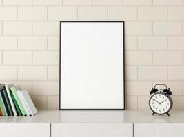 Minimalist vertical black poster or photo frame mockup on the desk with books and alarm in room. 3D Rendering.