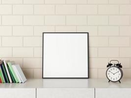 Minimalist square black poster or photo frame mockup on the desk with books and alarm in room. 3D Rendering.