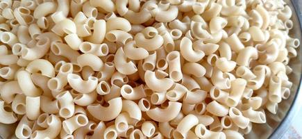 Dry macaroni pasta. Shot from above and filling the frame. photo