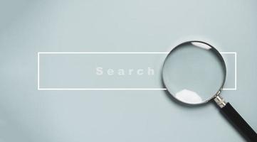 Magnifier glass with search bar icon for SEO or Search Engine Optimisation wording concept. photo