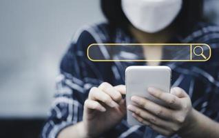 woman using smartphone with search icon for Search Engine Optimisation or SEO concept to find information by internet connection. photo