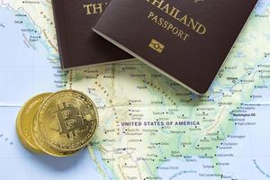 The golden bitcoins and passports were placed on the world map. photo