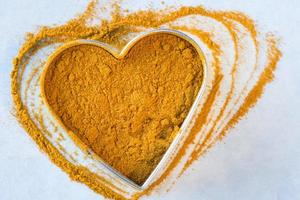 Ground Turmeric Root in a Heart Shape photo