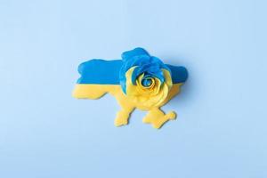 Map of Ukraine and a rose in the yellow-blue color of the national flag of Ukraine, top view photo