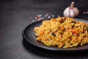 Pilaf or pilau with chicken, traditional uzbek hot dish of boiled rice, chicken meat, vegetables and spices photo