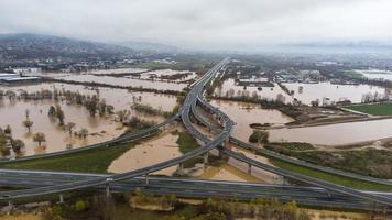 Aerial drone view of torrential rain causes flash floods in residential areas. Houses and roads surrounded by water. Climate change. Heavy rainfall consequences. photo