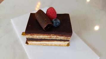 Opera cake at the a La carte desserts , cakes on a white background. Selective focus