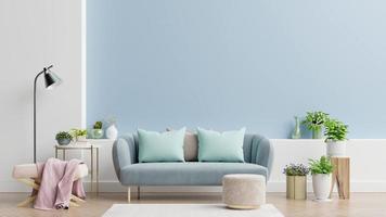 interior de una luminosa sala de estar con almohadas en un sofá y sillón, plantas y lámpara sobre fondo de pared azul vacío.