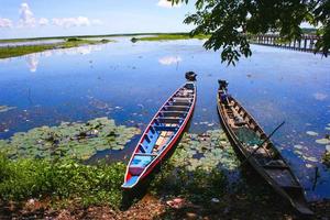 wooden boat takes a tour of the nature in the lake. photo