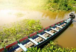 Old wooden boat moored by the lake photo