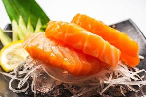 Sashimi, Salmon, Japanese food chopsticks and wasabi on the table photo