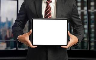 Business man holding and shows touch screen tablet with digital device, technology for smart working concepts photo