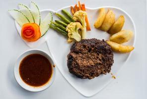 Table top view of Beef steak set on the white table. photo