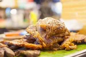 Roast beef resting on banana leaves and blurred background. photo