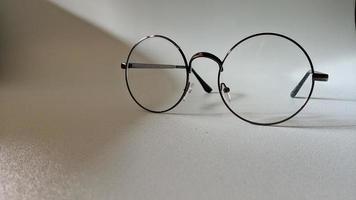 Background photo of clear round glasses.