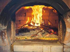 Close-up of pizza in an antique stove oven photo