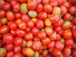 Pile of red tomatoes for sale in market