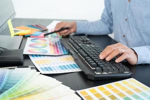 creative graphic designer choosing color scale for editing artwork while working in office.