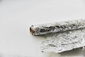 Aluminum foil roll on white background photo