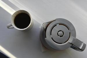 Glass coffee jug with a drink on a white background photo