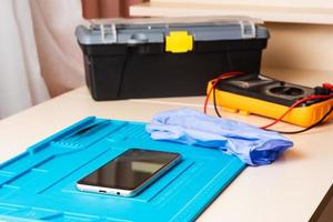 Flat lay image of dismantling the broken smart phone for preparing to repair or replace some components, Top view photo