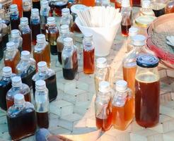 Several varieties of natural honey in bottles from different flower plants. photo