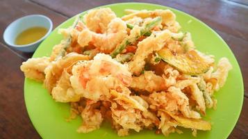 Thai style shrimps and vegetable tempura on green plate. photo