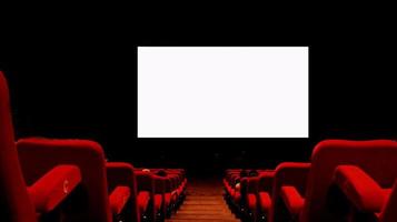 Empty cinema auditorium with empty white screen.