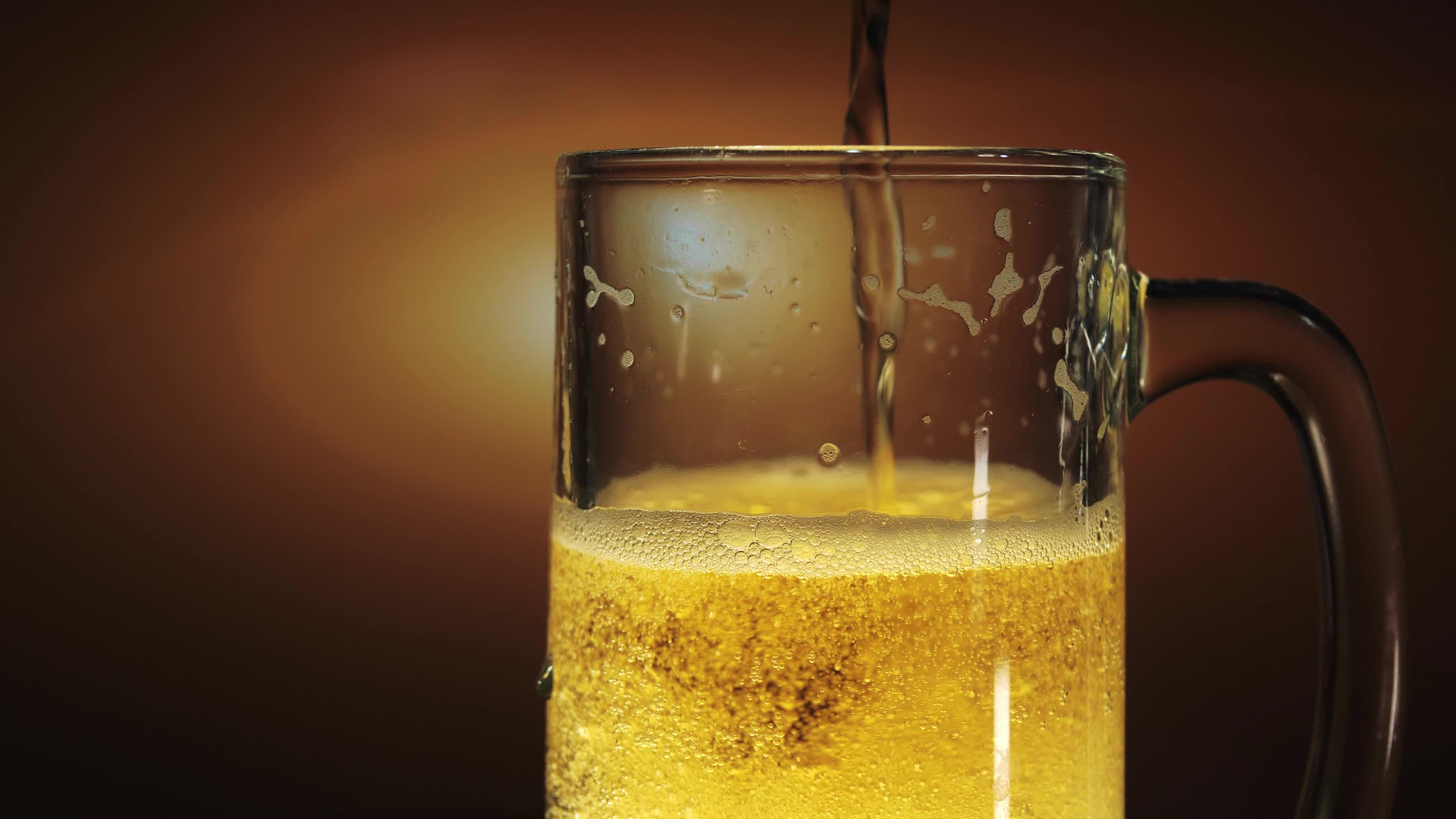 pour beer into a glass to fill And there are many more beer foams until