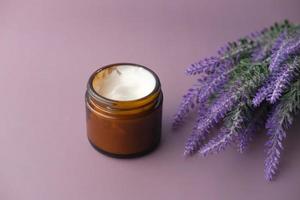 herbal cream cosmetic in a container on table, photo