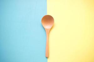 wooden cutlery forks on light yellow background photo