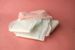 close up of sanitary pad on a pink background photo