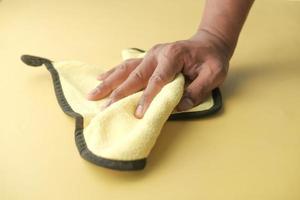 close up of person hand cleaning table with cloth photo