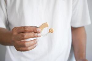 Hearing aid concept, a young man with hearing problems. photo