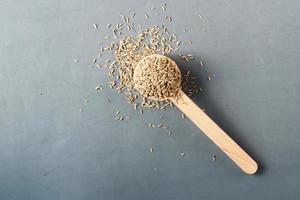 cumin seeds on spoon on table , top view photo