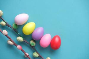 easter concept with multi color egg and flower on light green background photo