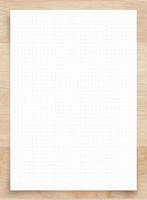 White paper with grid line pattern on wood, use for background. photo